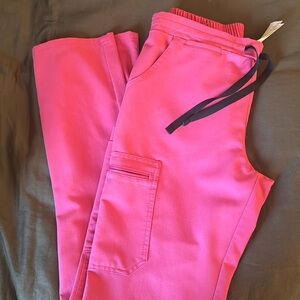 Figs Yola scrub pants. Pink with navy tie.
